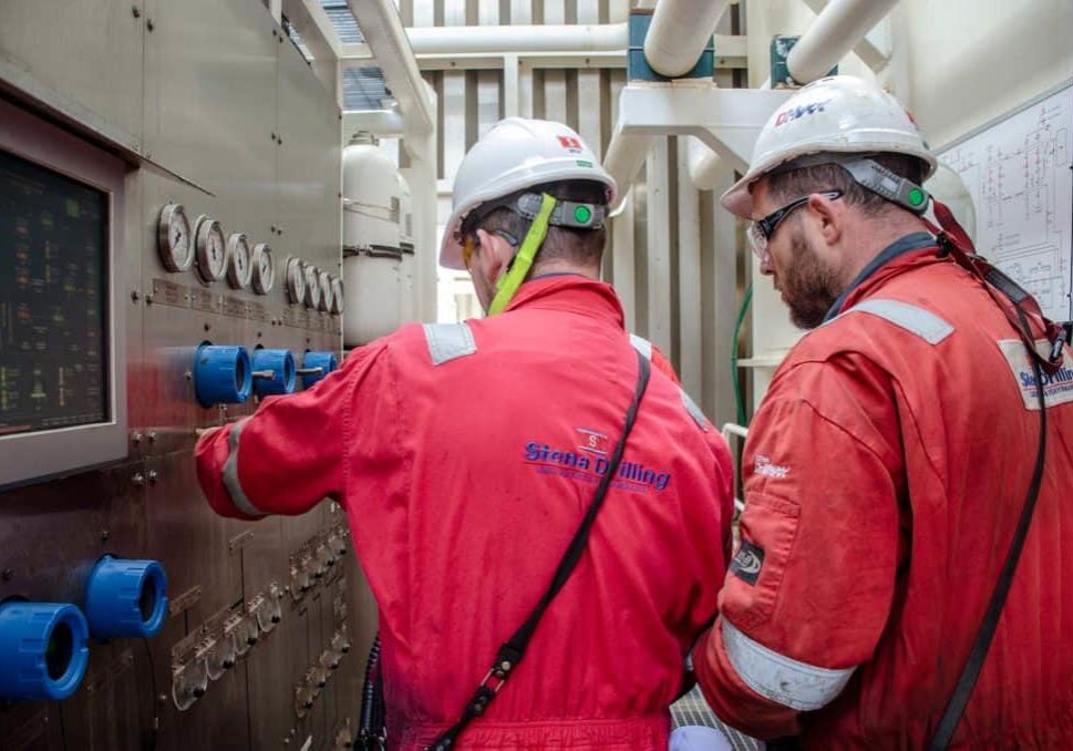 Drillship crew wearing red suits